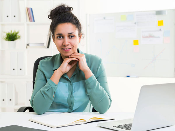 Woman sitting at tidy desk