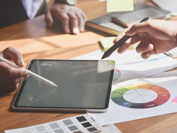 people-holding-white-stylus-writing-on-black-tablet-computer-3740417