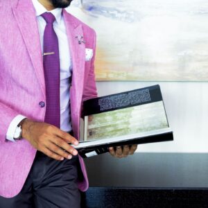 young professional in bright pink suit reading book